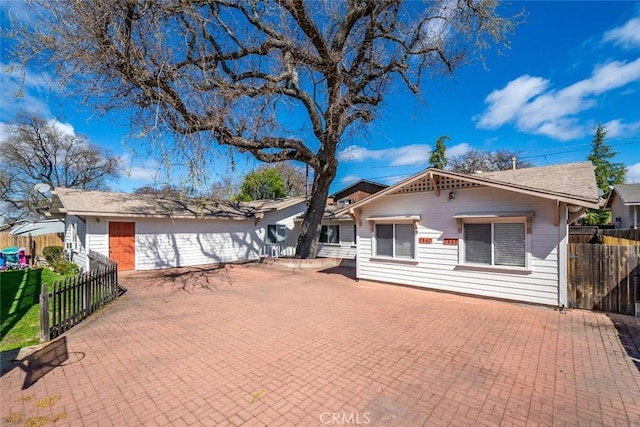 single story home with fence