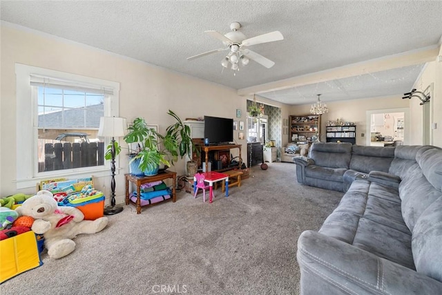 living room with plenty of natural light, a textured ceiling, ceiling fan, and carpet flooring