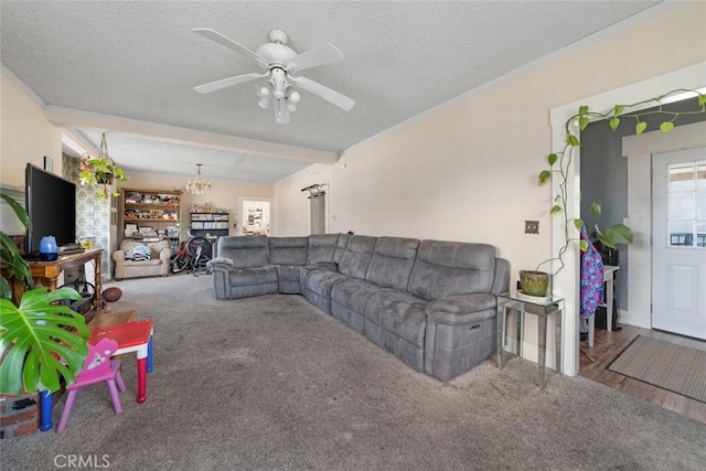 living area featuring carpet flooring, a textured ceiling, and a ceiling fan