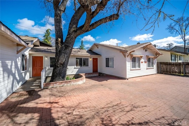 single story home with fence