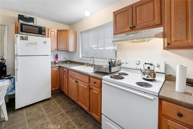 kitchen with under cabinet range hood, a sink, white appliances, brown cabinetry, and light countertops