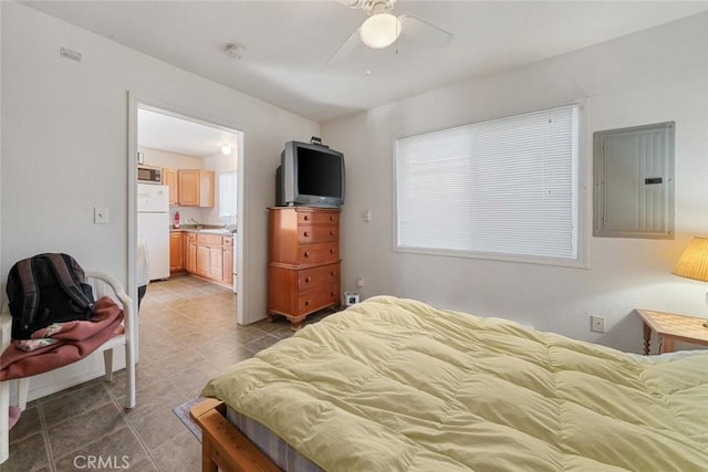 bedroom featuring a ceiling fan, electric panel, ensuite bath, freestanding refrigerator, and light tile patterned flooring