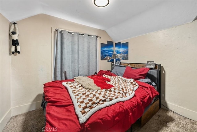 bedroom featuring baseboards, lofted ceiling, and carpet