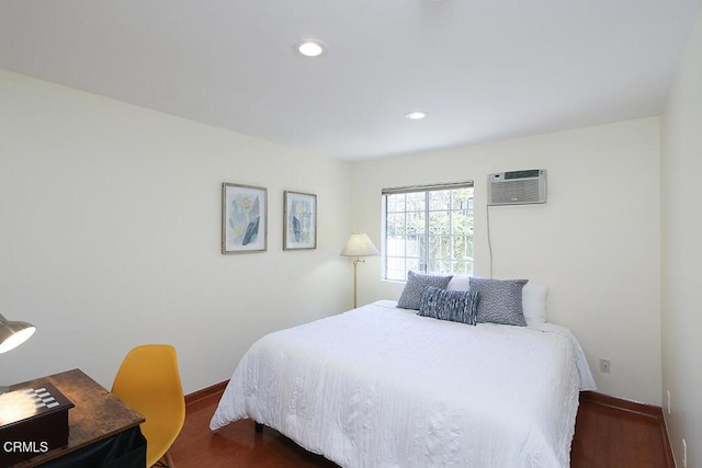 bedroom featuring recessed lighting, baseboards, dark wood finished floors, and a wall mounted AC