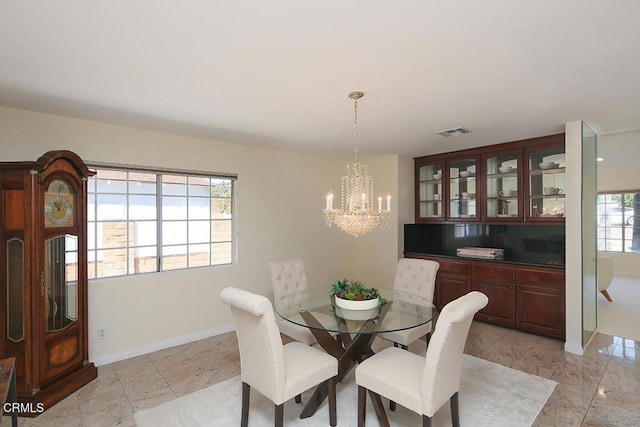 dining space featuring baseboards and visible vents