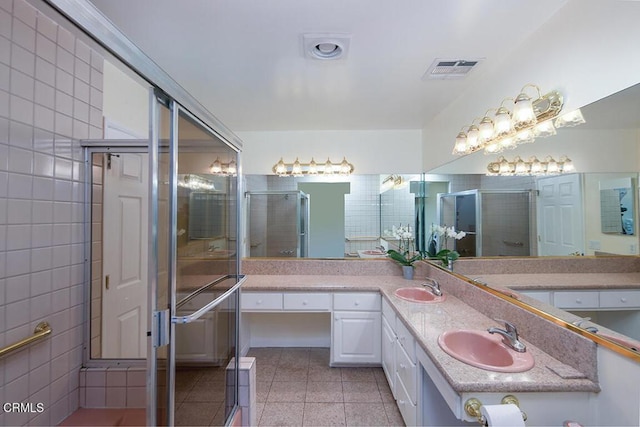 bathroom featuring tile patterned floors, visible vents, double vanity, and a sink