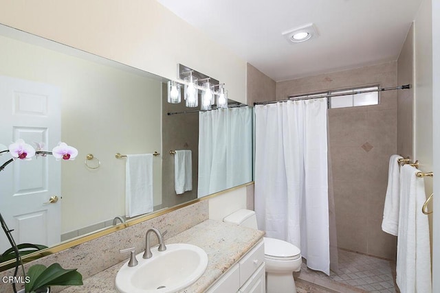 full bathroom with vanity, tile patterned floors, toilet, and tiled shower