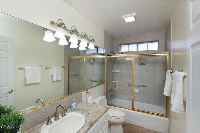 full bath with vanity, toilet, and enclosed tub / shower combo