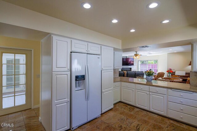 kitchen featuring white cabinetry, recessed lighting, white fridge with ice dispenser, and ceiling fan