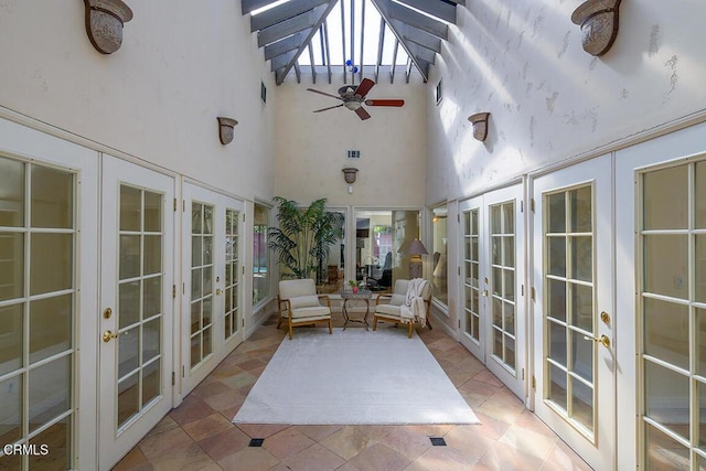 sunroom / solarium featuring french doors and ceiling fan