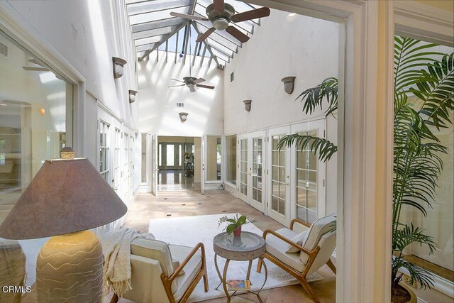 sunroom with visible vents, french doors, lofted ceiling, and ceiling fan