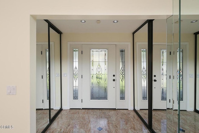 foyer entrance with recessed lighting and baseboards