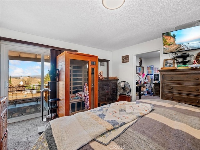 carpeted bedroom featuring access to outside and a textured ceiling