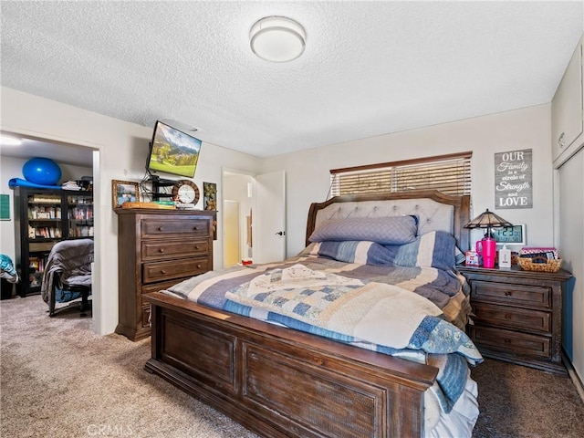 bedroom featuring light carpet and a textured ceiling