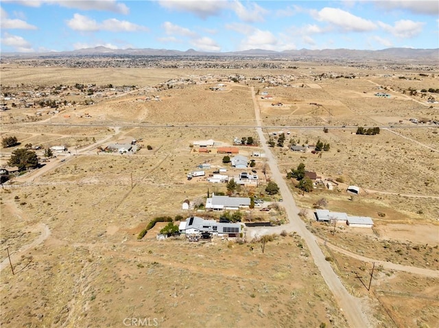 birds eye view of property with view of desert, a rural view, and a mountain view