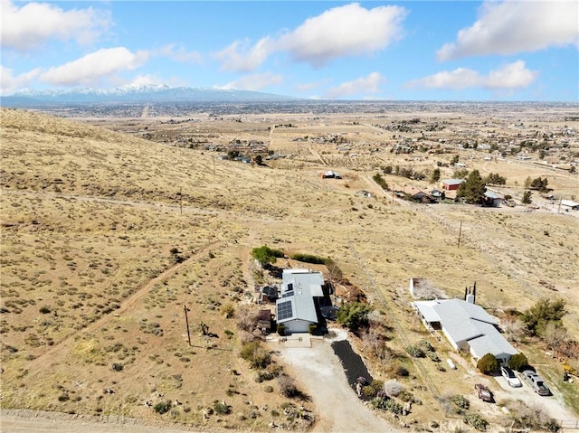 birds eye view of property featuring a mountain view, a rural view, and a desert view