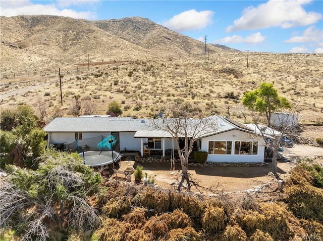 rear view of property featuring a patio and a mountain view