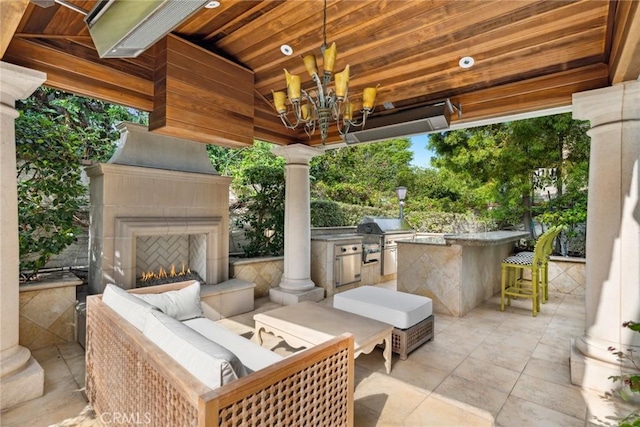 view of patio / terrace featuring area for grilling and an outdoor living space with a fireplace