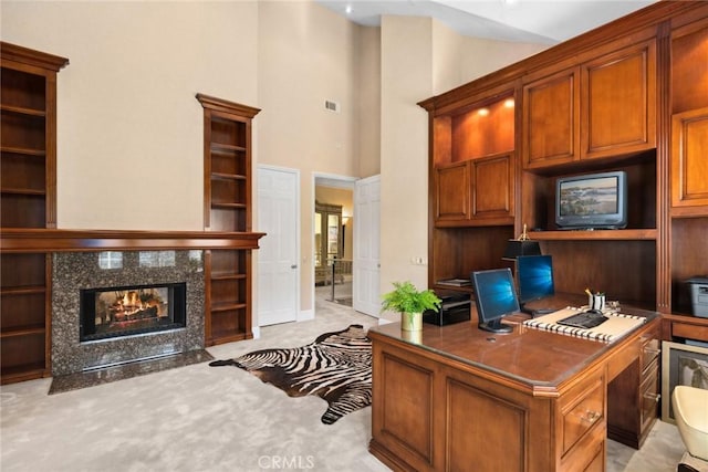 office area featuring high vaulted ceiling, visible vents, light colored carpet, and a tiled fireplace