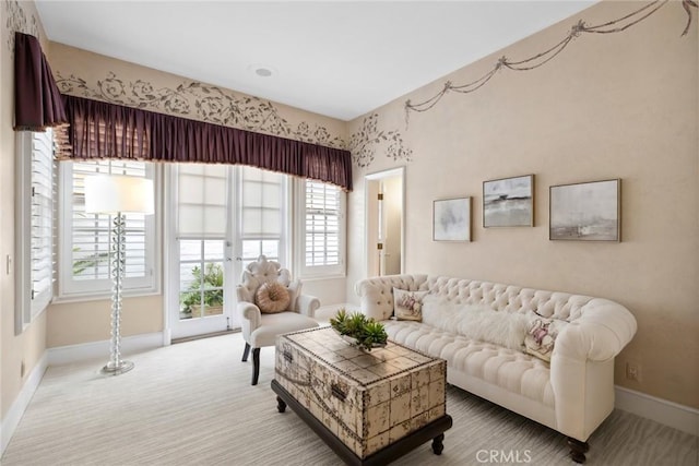 carpeted living room featuring baseboards