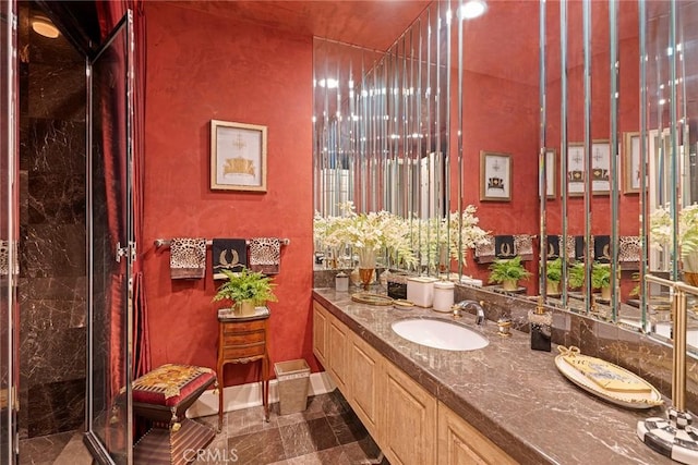 bathroom with a shower with door and vanity