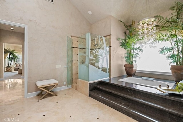 full bathroom with a shower stall, a garden tub, and vaulted ceiling