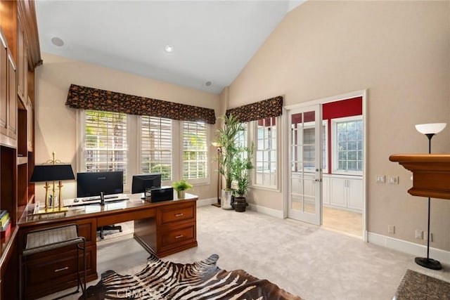 office area with french doors, plenty of natural light, and light colored carpet