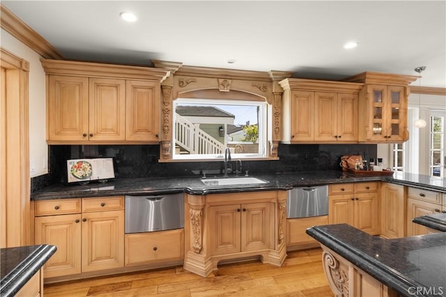 kitchen with a sink, tasteful backsplash, a warming drawer, and light wood finished floors