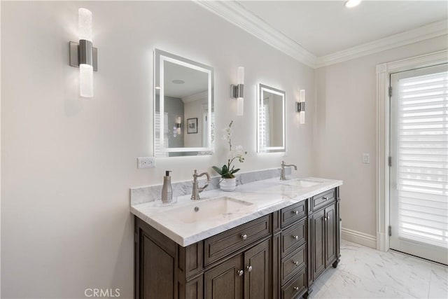full bath with double vanity, marble finish floor, crown molding, and a sink
