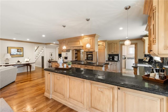 kitchen with ornamental molding, recessed lighting, a peninsula, light wood-style floors, and gas stovetop