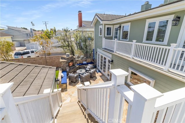 exterior space featuring a tiled roof, a balcony, and a chimney