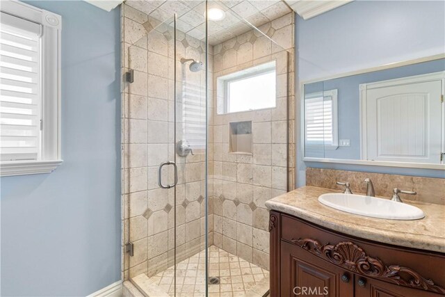 bathroom with a stall shower and vanity