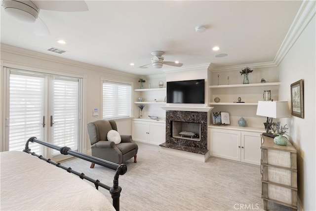 bedroom with visible vents, a high end fireplace, ornamental molding, light carpet, and access to outside