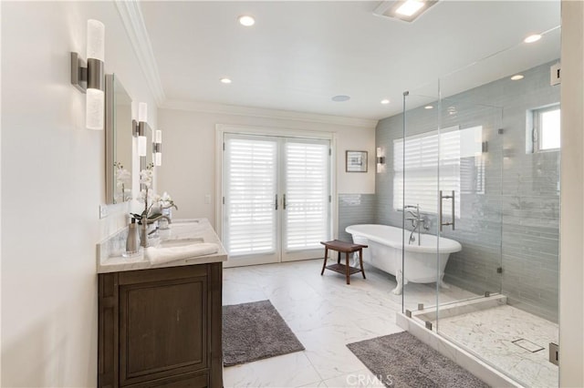 full bathroom featuring a soaking tub, a shower stall, marble finish floor, and crown molding