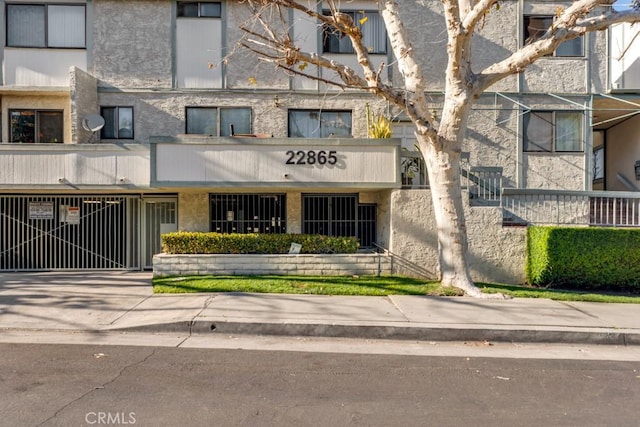 view of building exterior featuring concrete driveway