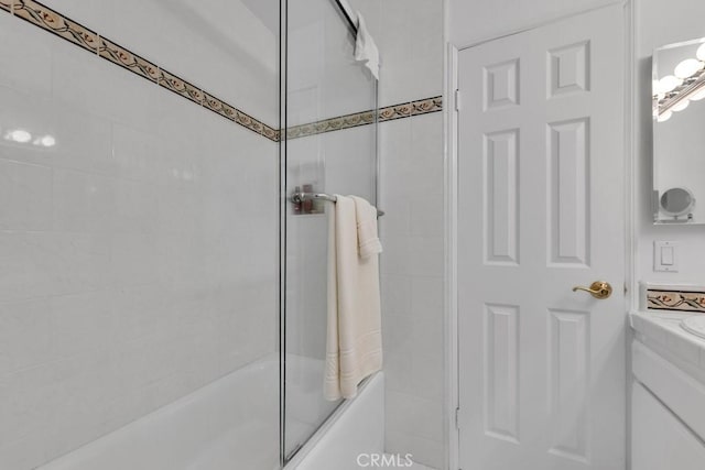 full bath featuring enclosed tub / shower combo and vanity