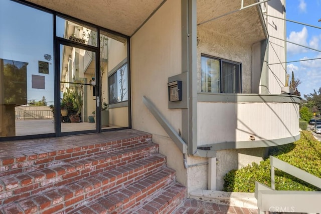 doorway to property with stucco siding