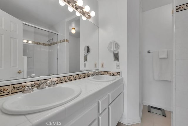 bathroom featuring tile patterned flooring, a shower stall, double vanity, and a sink