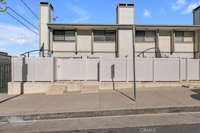 exterior space featuring fence and a chimney