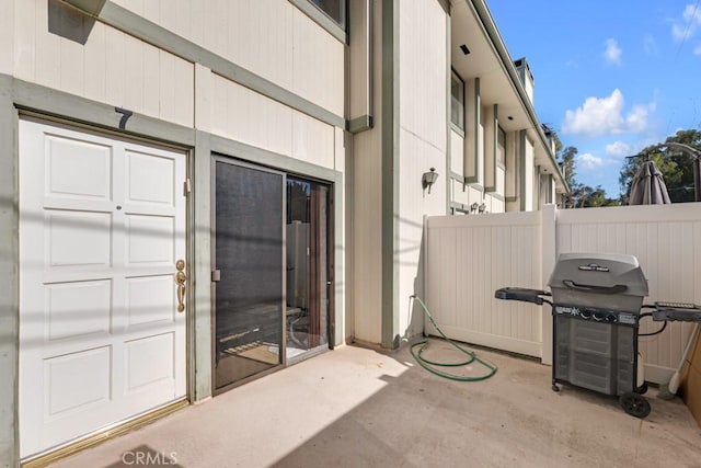 entrance to property featuring a patio and fence