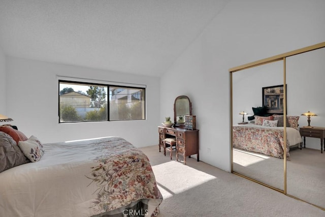 bedroom featuring a closet, high vaulted ceiling, and carpet