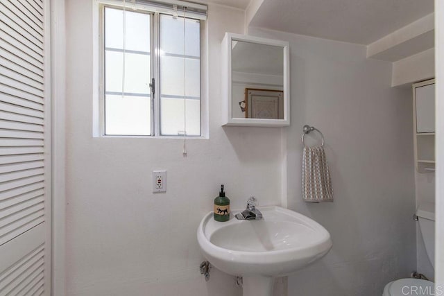 bathroom featuring toilet and a sink