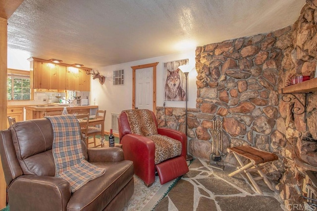 living room featuring visible vents and a textured ceiling