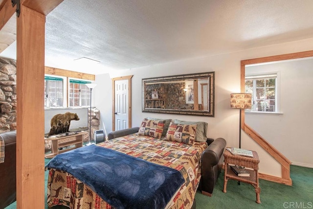 carpeted bedroom featuring baseboards and a textured ceiling