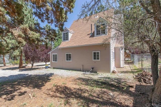 back of house featuring fence