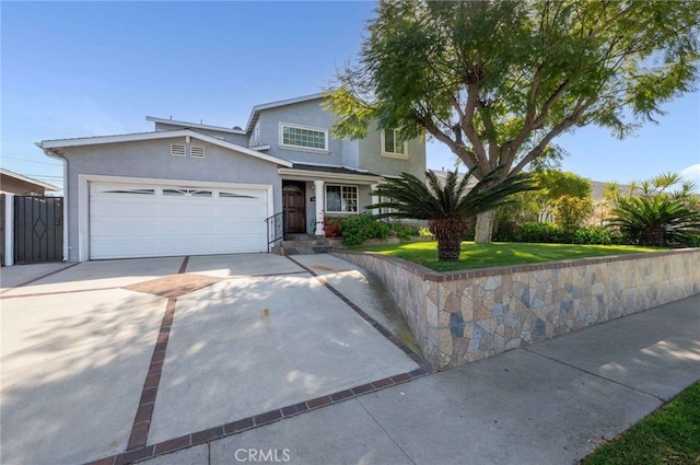 traditional home with stucco siding, a garage, and concrete driveway