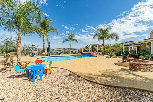 view of swimming pool featuring a patio area, a fenced in pool, and fence