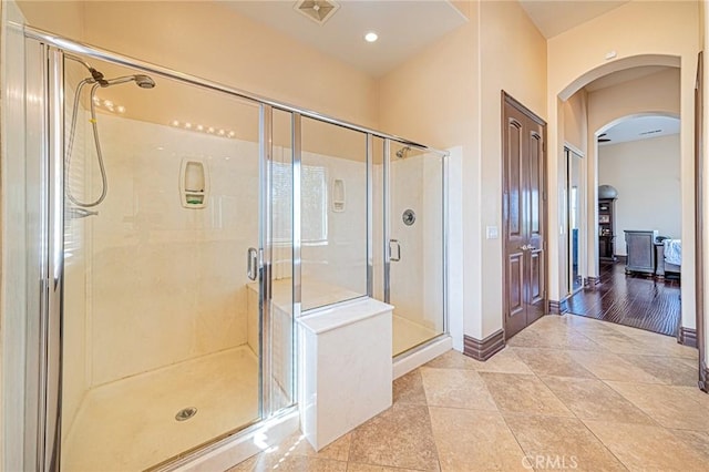 bathroom with tile patterned floors, visible vents, baseboards, and a shower stall