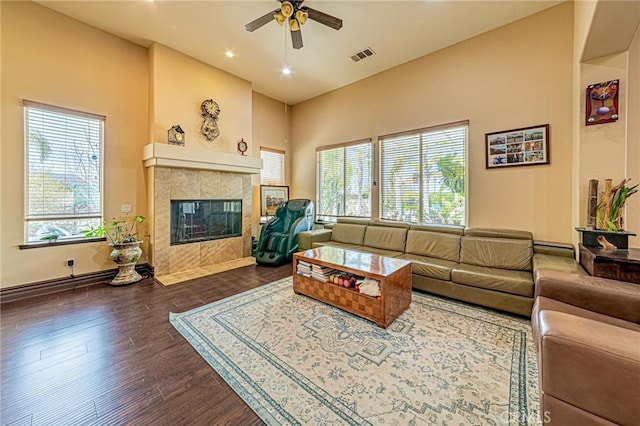 living room with visible vents, recessed lighting, dark wood-style flooring, ceiling fan, and a tile fireplace