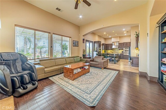 living room featuring visible vents, recessed lighting, wood finished floors, arched walkways, and a ceiling fan